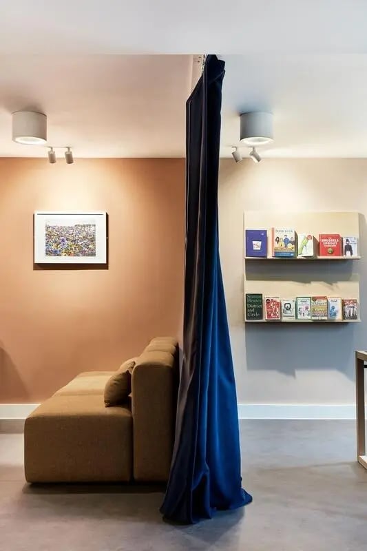 Sofa artwork blue curtain books living room at Hollis Wharf in Bath Student Accommodation
