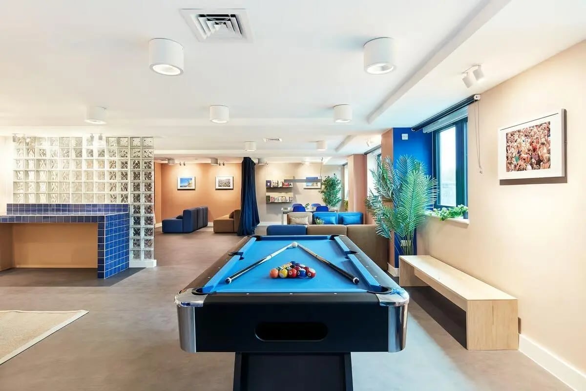 Pool table couches glass block wall communal area at Hollis Wharf in Bath Student Accommodation