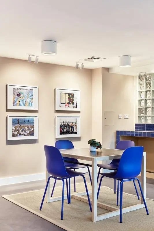 Four blue chairs surrounding dining table common area at Hollis Wharf in Bath Student Accommodation