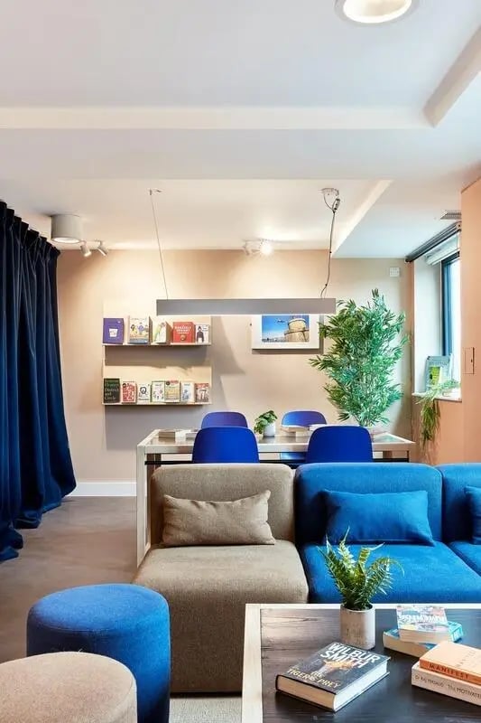 Sofa table chairs and books living room at Hollis Wharf in Bath Student Accommodation