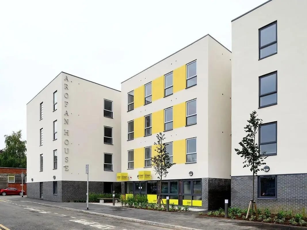 Modern white buildings yellow accents exterior at Yugo Arofan House in Cardiff Student Accommodation