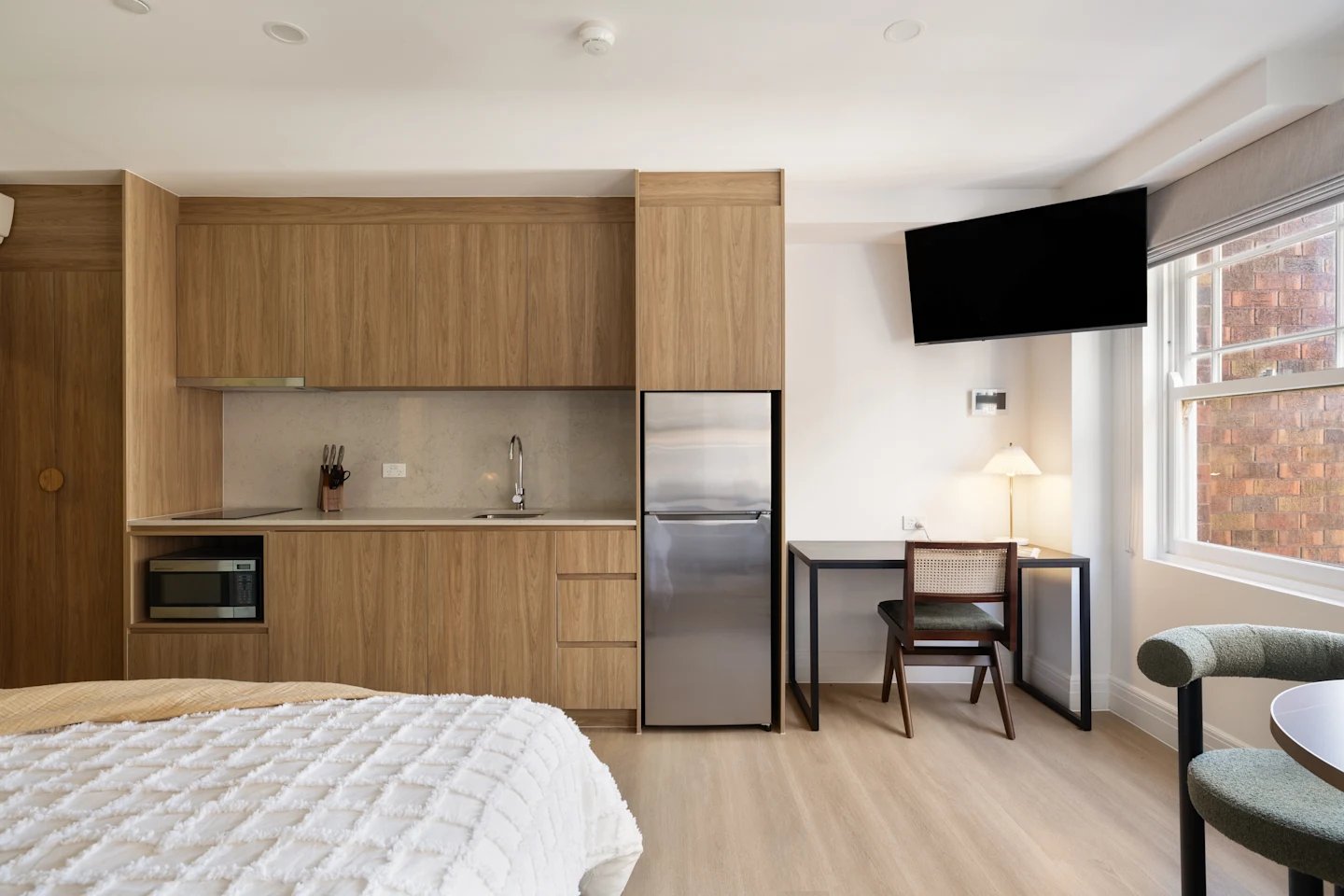 Bed microwave fridge desk TV living area studio at UKO Potts Point in Sydney Student Accommodation
