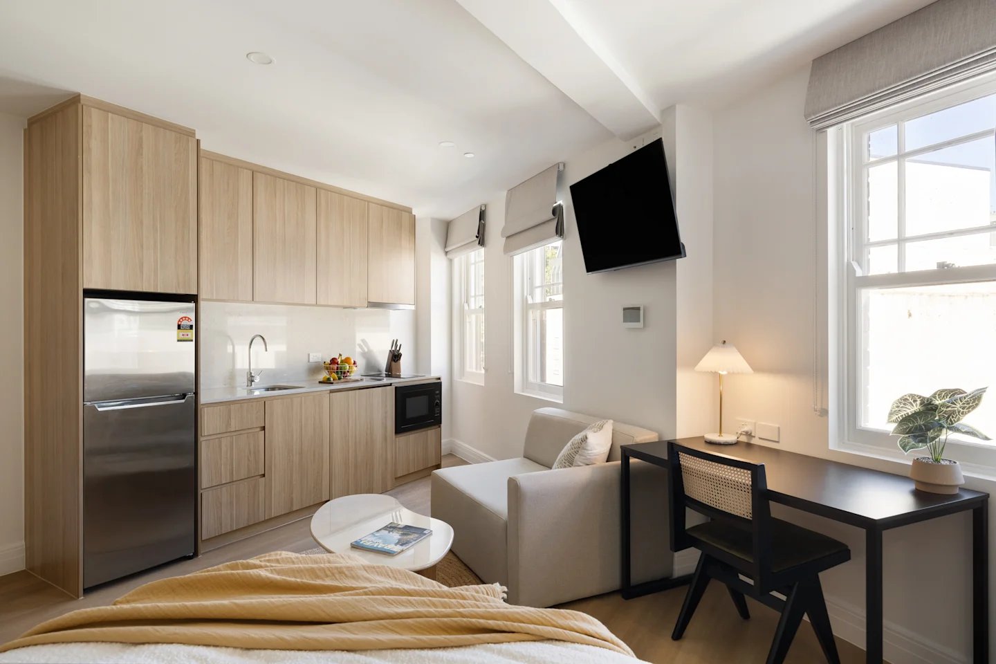 Kitchen, desk, sofa, bed, living room at UKO Potts Point in Sydney Student Accommodation