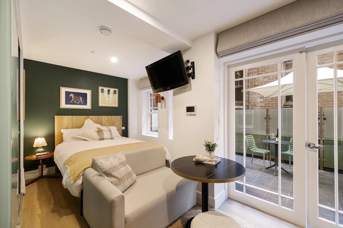 Bed sofa tv and patio bedroom at UKO Potts Point in Sydney Student Accommodation