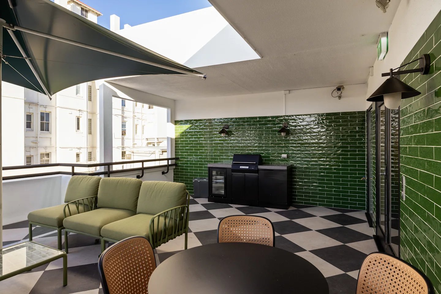 Sofa grill black cabinets outdoor dining patio area at UKO Potts Point in Sydney Student Accommodation