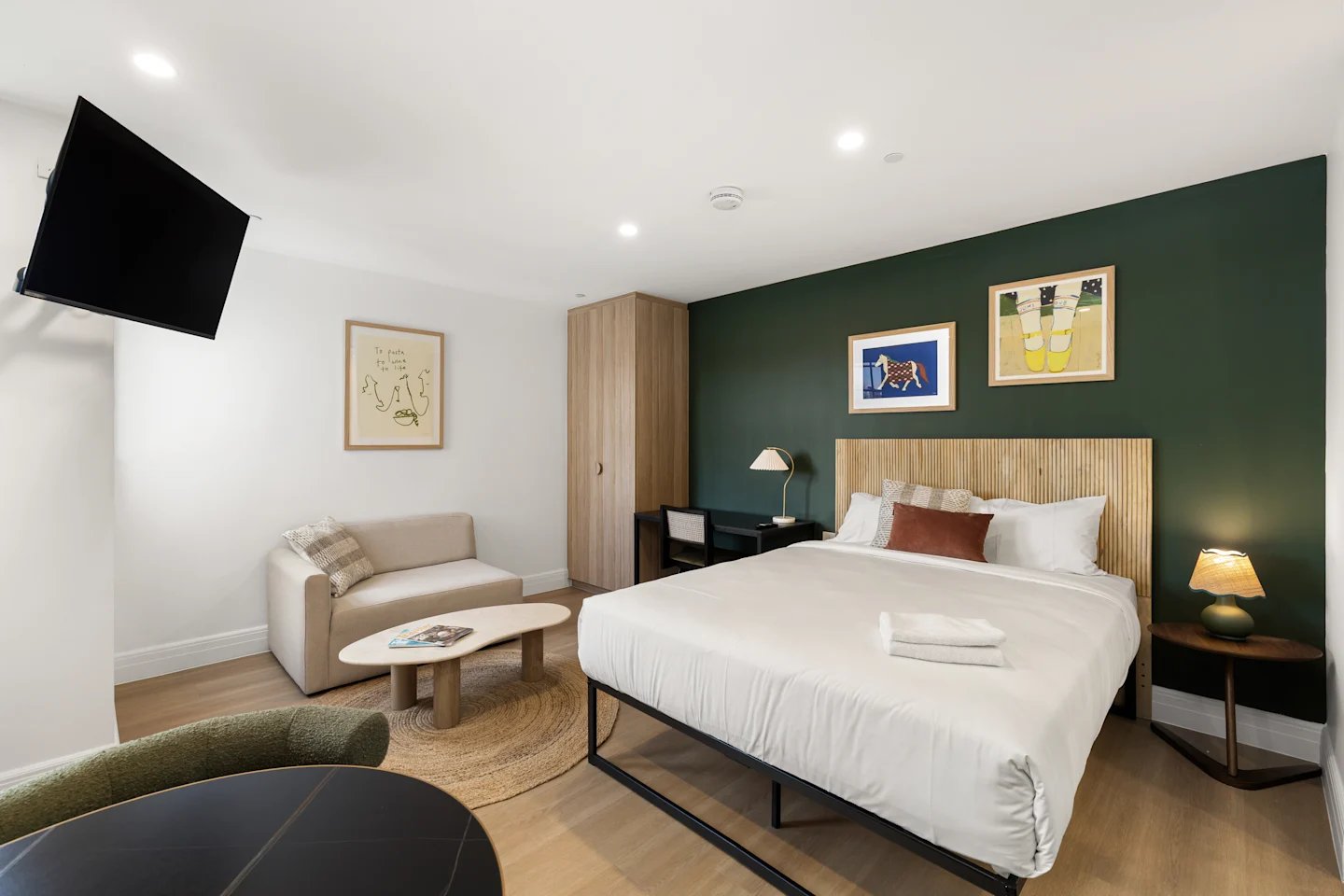 Bed sofa TV wardrobe and artwork bedroom at UKO Potts Point in Sydney Student Accommodation