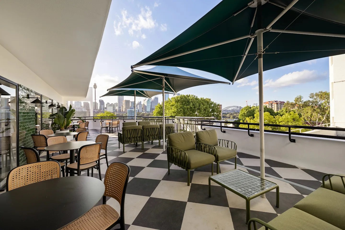 Outdoor seating with tables chairs and umbrellas patio at UKO Potts Point in Sydney Student Accommodation
