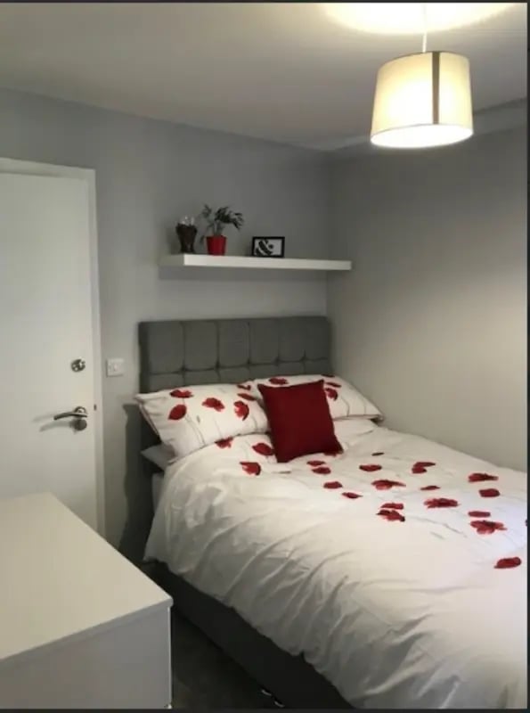 Bed with red poppies and petals bedroom at Varsity Beeston in Nottingham Student Accommodation