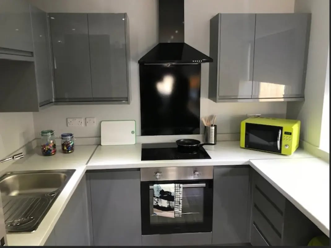 Modern grey kitchen with microwave oven and hob kitchen at Varsity Beeston in Nottingham Student Accommodation