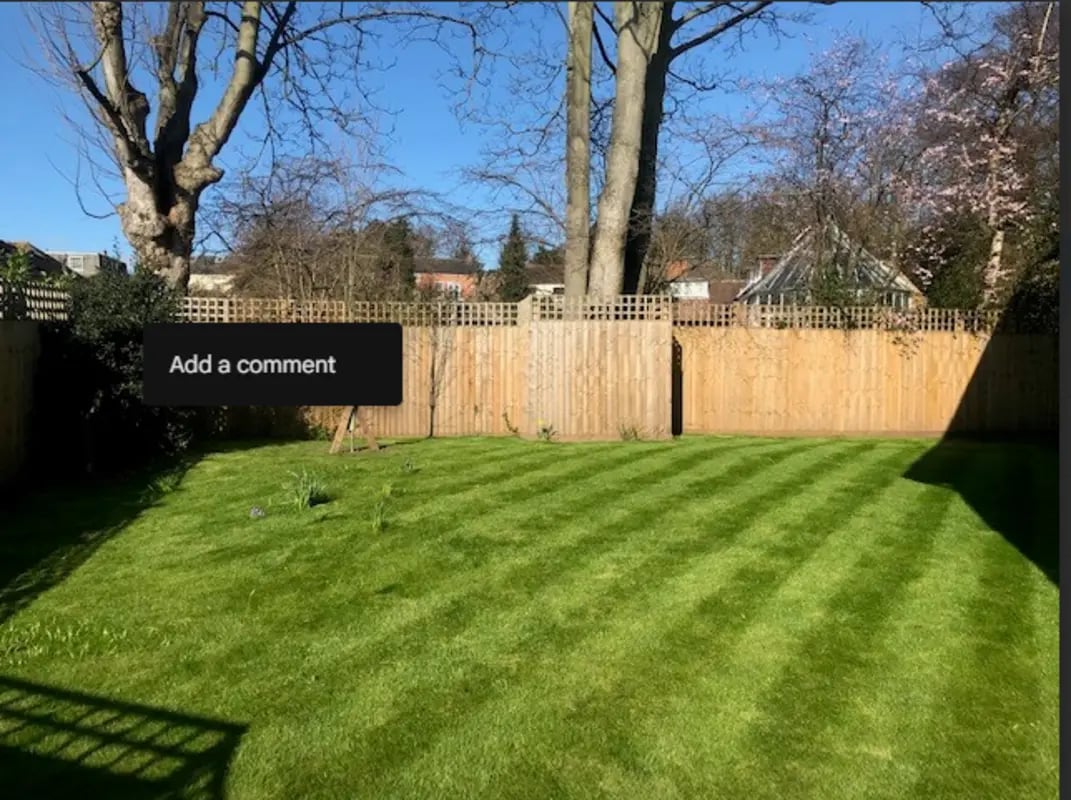 Freshly cut green lawn with wooden fence exterior at Varsity Beeston in Nottingham Student Accommodation