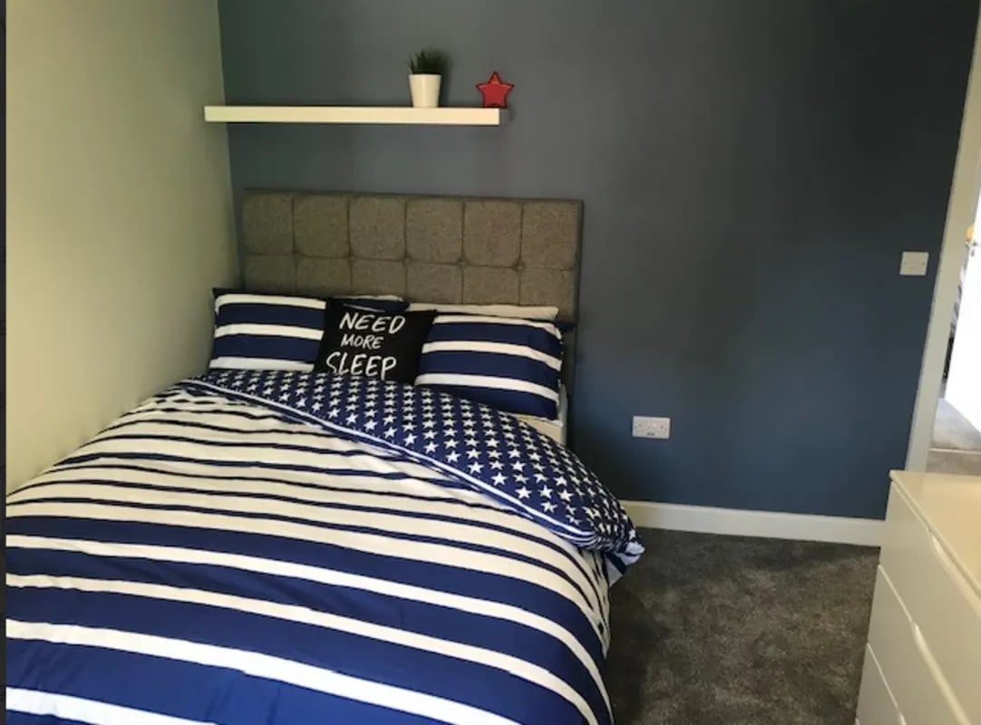 Bed with blue white bedding and pillow bedroom at Varsity Beeston in Nottingham Student Accommodation