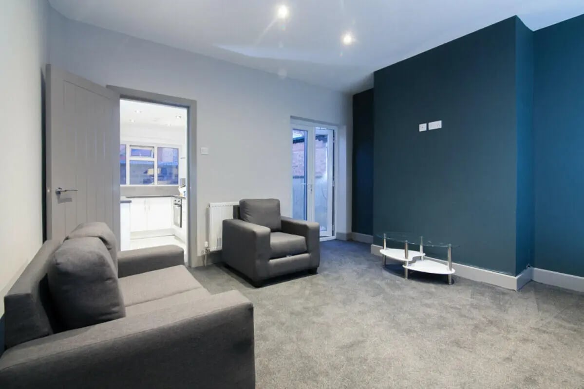 Grey sofa armchair coffee table living room at 3 Bedroom House at 93, Gerald Road in Salford Student Accommodation