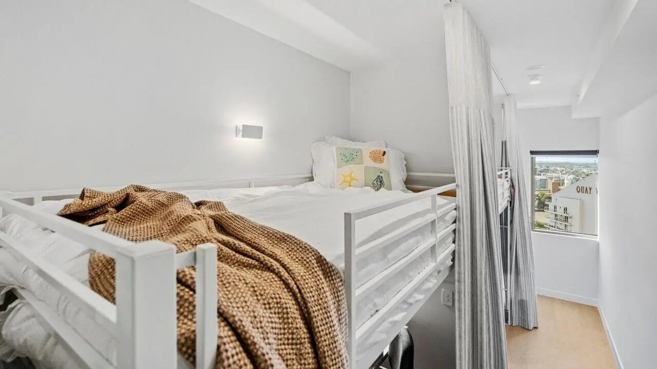 Bunk bed with white bedding and brown blanket bedroom at UniLodge Brisbane City in Brisbane Student Accommodation