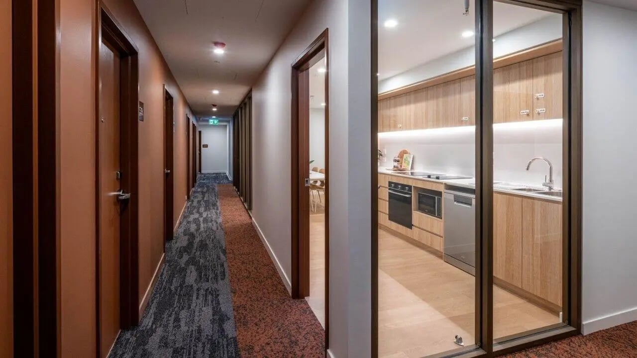 Hallway with doors and modern kitchen area at UniLodge Brisbane City in Brisbane Student Accommodation