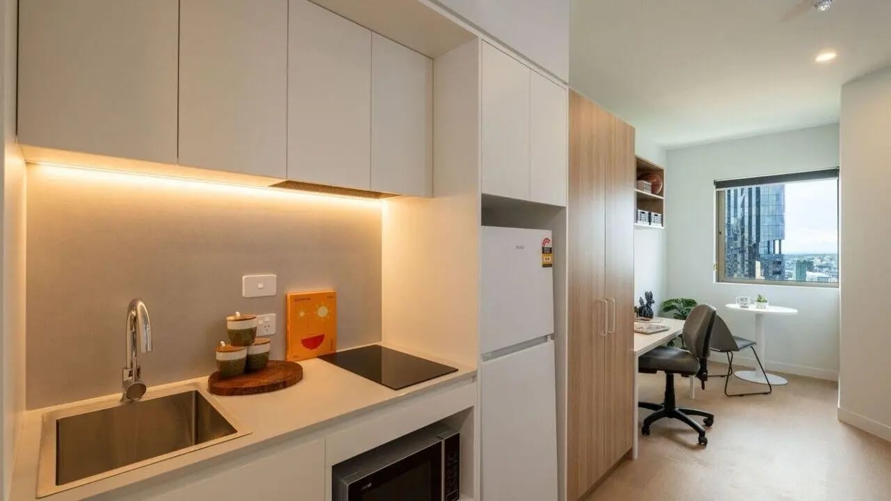 Kitchen area with study desk window and city view living room at UniLodge Brisbane City in Brisbane Student Accommodation