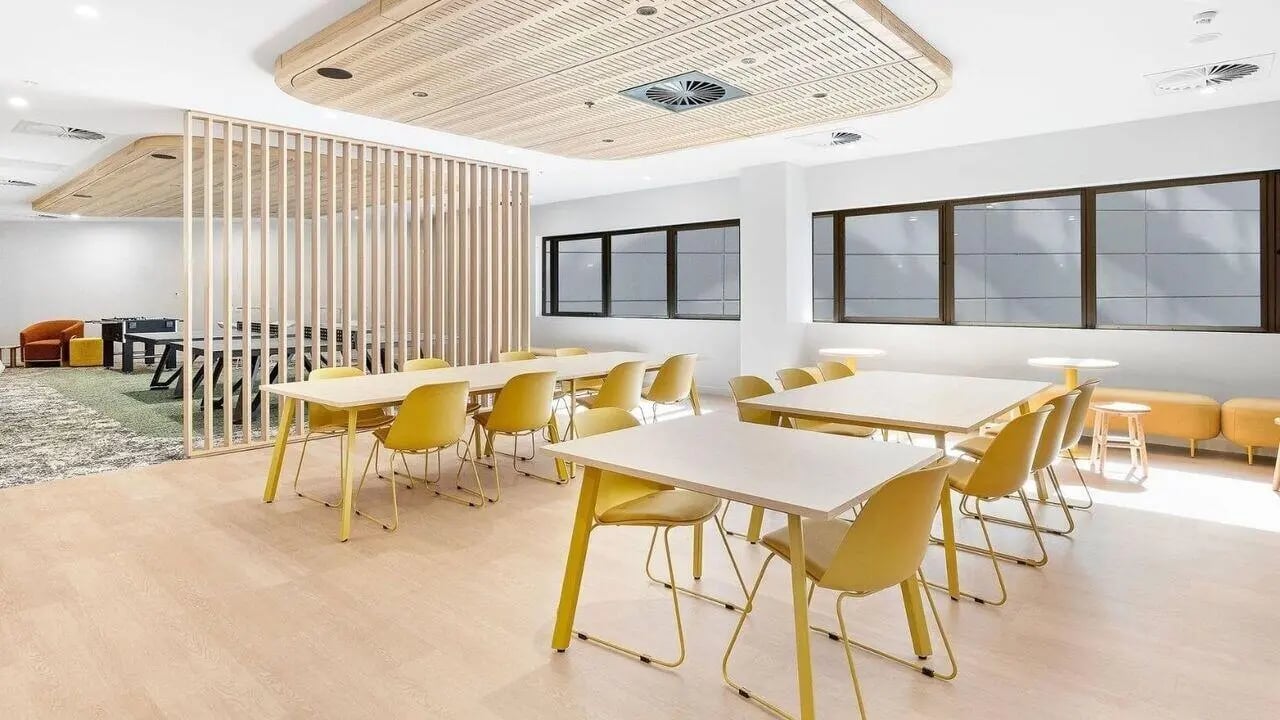 Yellow chairs tables wooden divider common area at UniLodge Brisbane City in Brisbane Student Accommodation