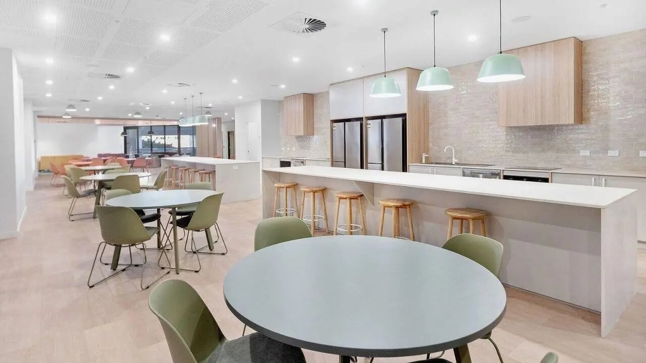 Kitchen with tables chairs and bar stools kitchen at UniLodge Brisbane City in Brisbane Student Accommodation