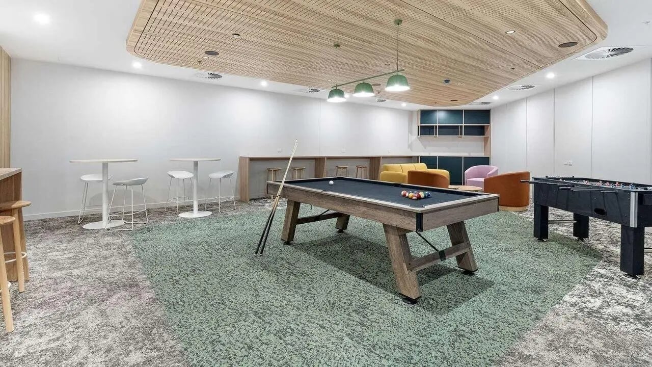 Billiard table foosball table lounge chairs common area at UniLodge Brisbane City in Brisbane Student Accommodation