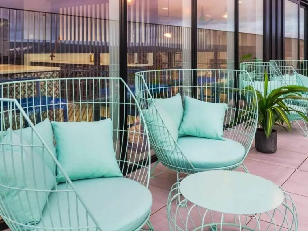 Aqua chairs and table on patio exterior at Bridle Works Glasgow in Glasgow Student Accommodation
