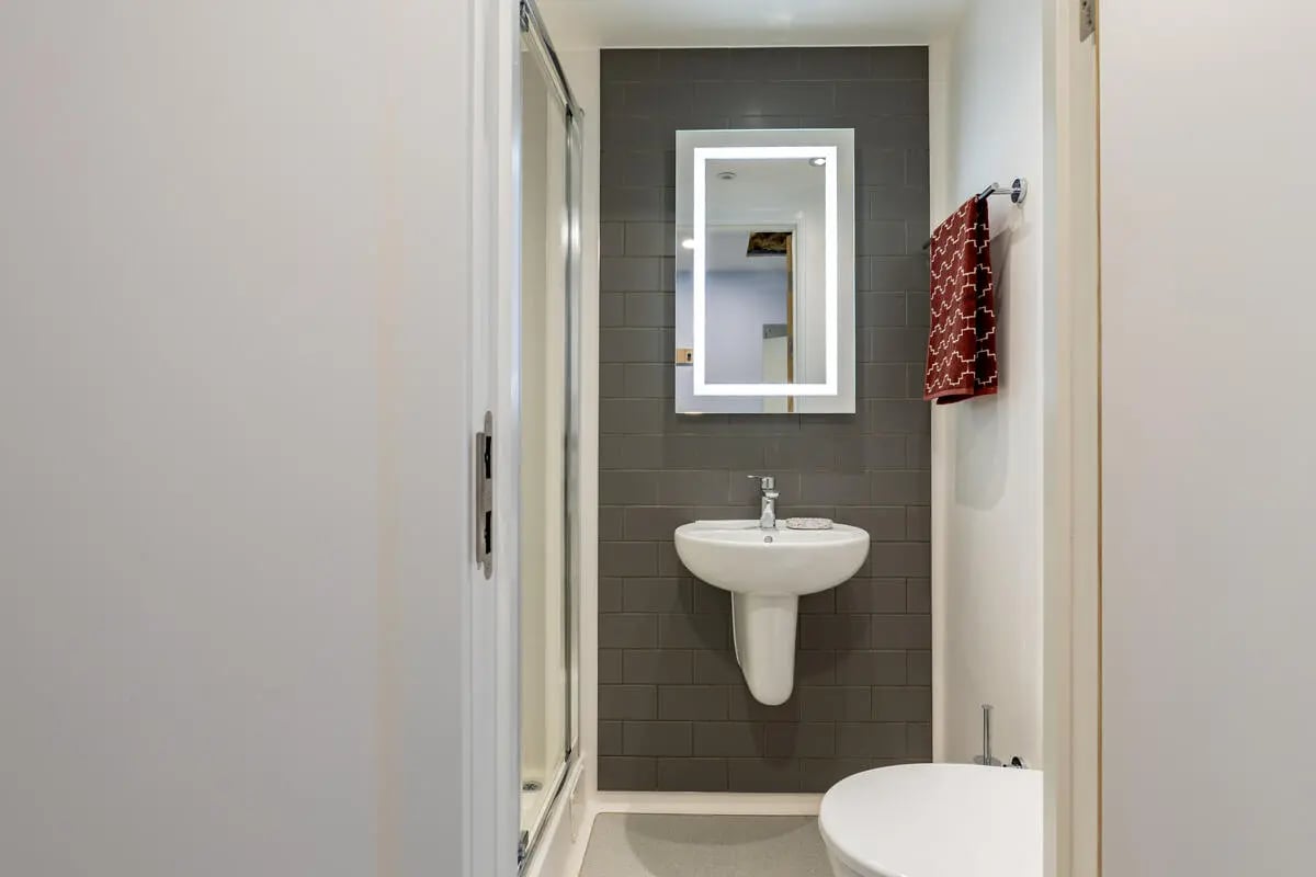 Sink toilet shower and illuminated mirror bathroom at Croft Court in Bristol Student Accommodation