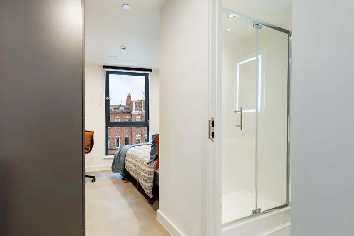 Bed desk and modern shower stall bathroom at Croft Court in Bristol Student Accommodation