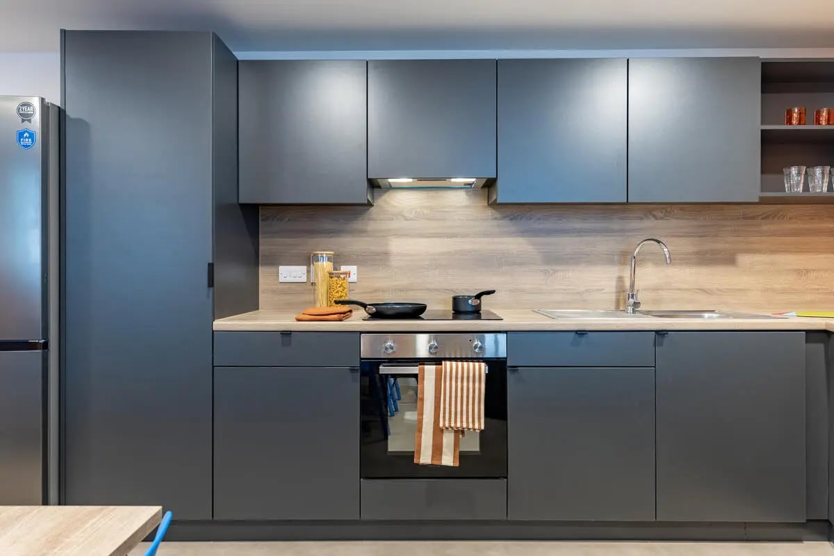 Modern gray student kitchen with oven and sink kitchen at Croft Court in Bristol Student Accommodation