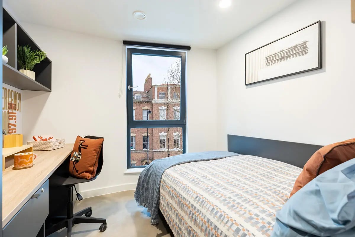 Desk plant bed and window bedroom at Croft Court in Bristol Student Accommodation