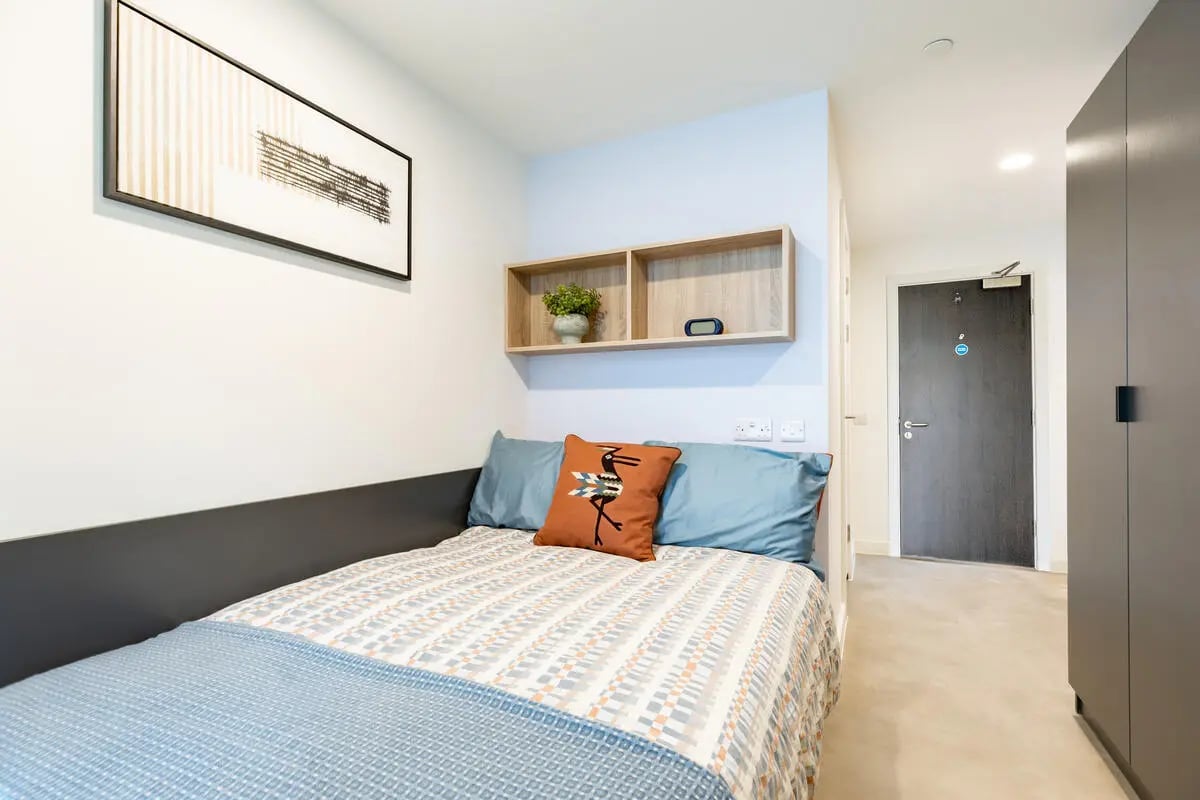 Bed with patterned bedding artwork and shelf bedroom at Croft Court in Bristol Student Accommodation