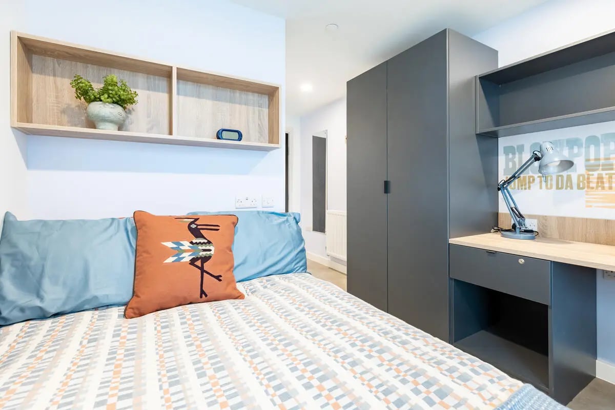 Bed with pillows lamp and closet bedroom at Croft Court in Bristol Student Accommodation