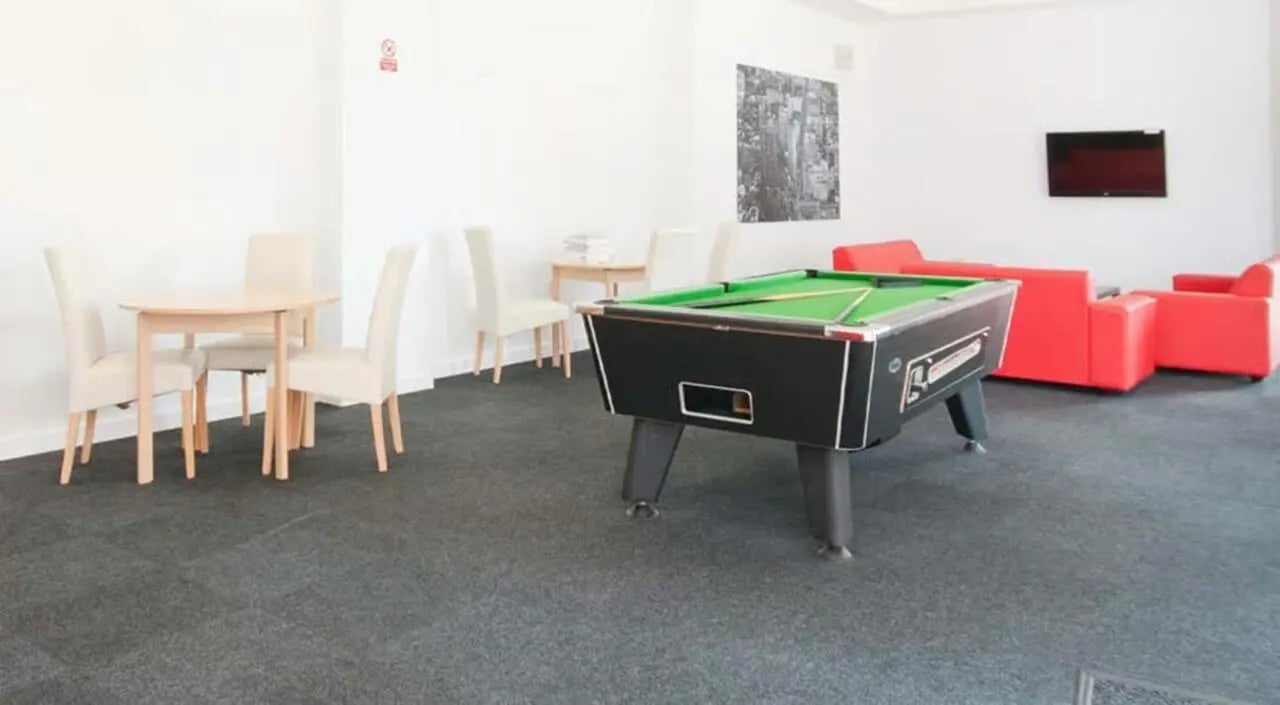 Pool table chairs and red sofas Common room at Brayford Quay in Lincoln Student Accommodation