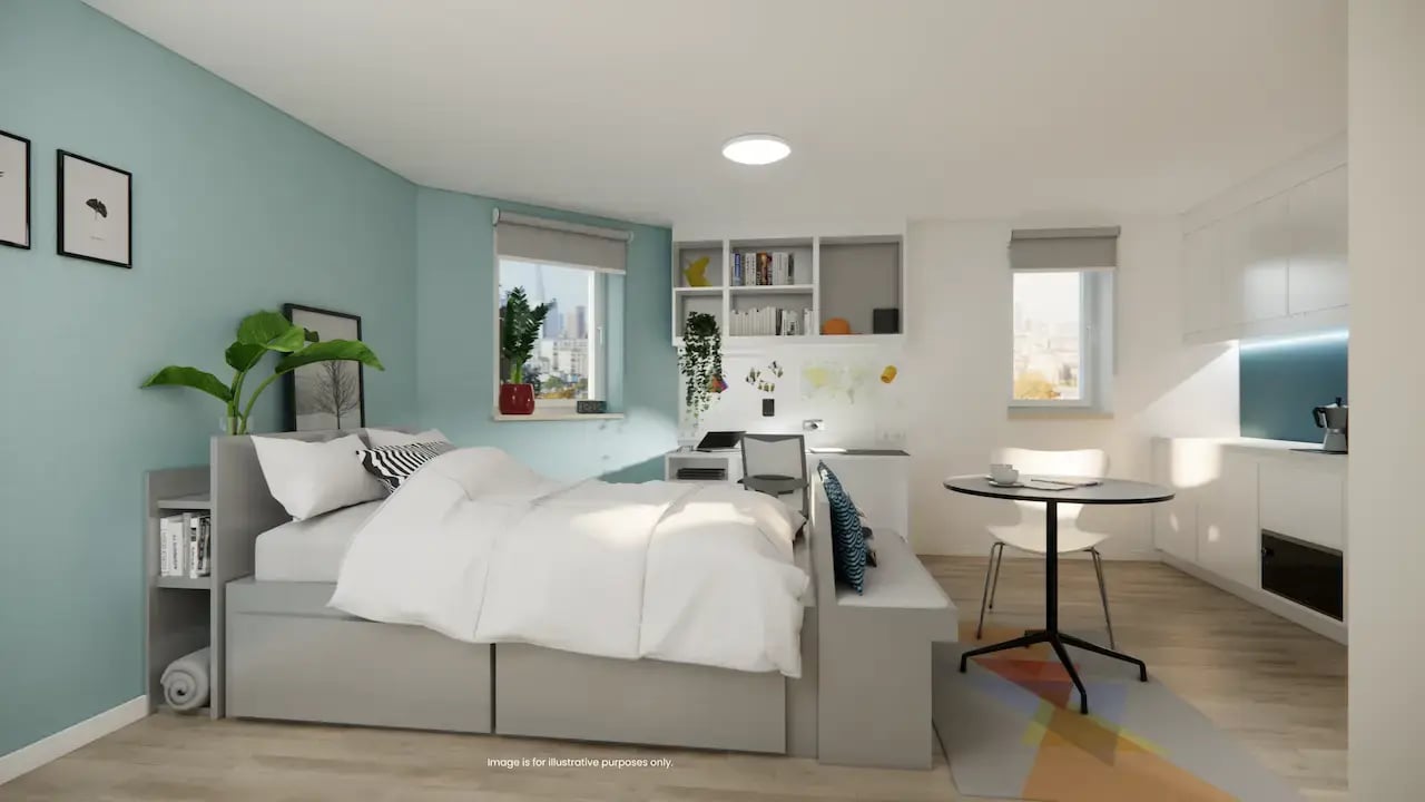 Bed desk kitchen and round table student studio at Mcmillan student Village in Greenwich Student Accommodation