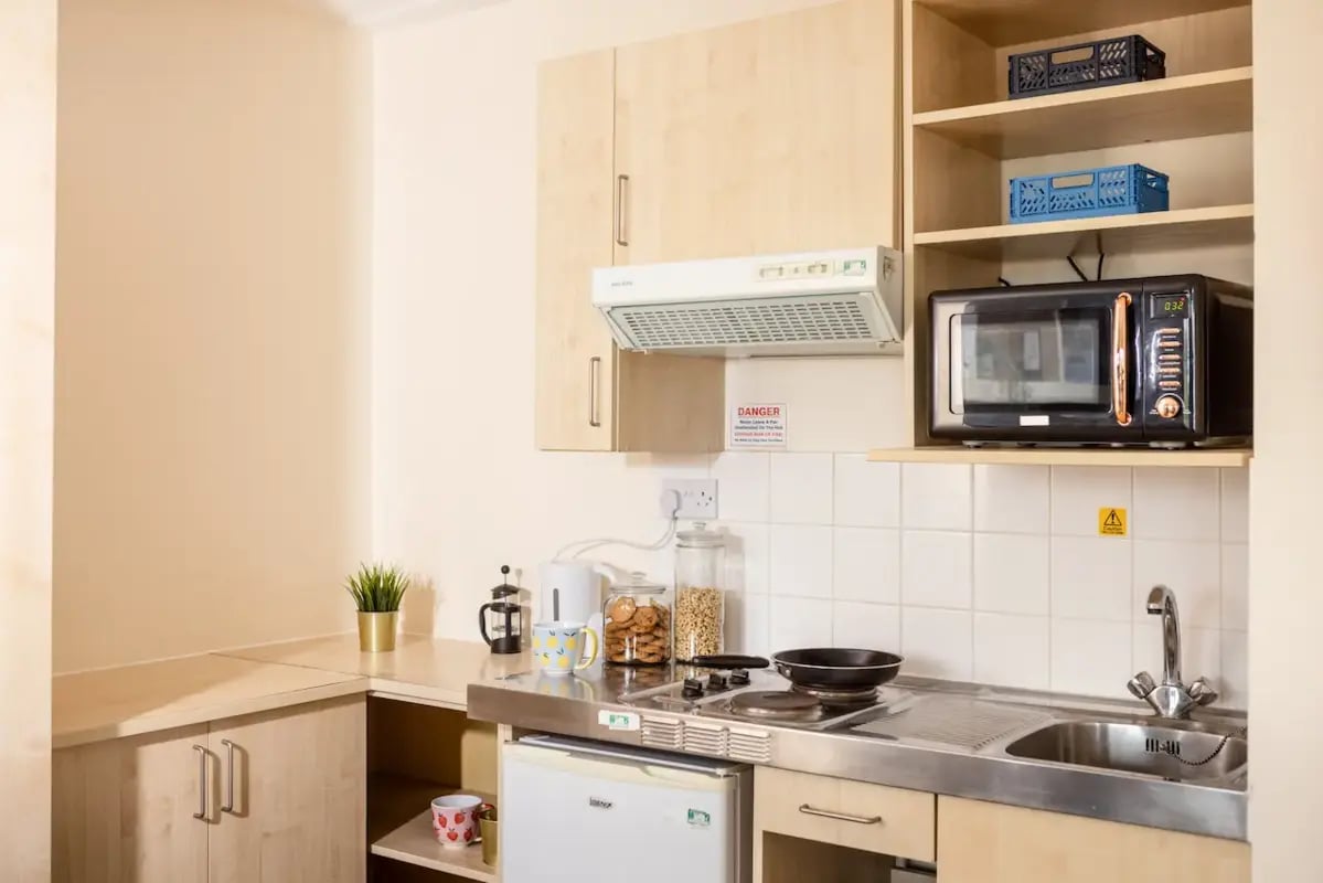 Compact kitchen with microwave stove sink and fridge kitchen at Mcmillan student Village in Greenwich Student Accommodation