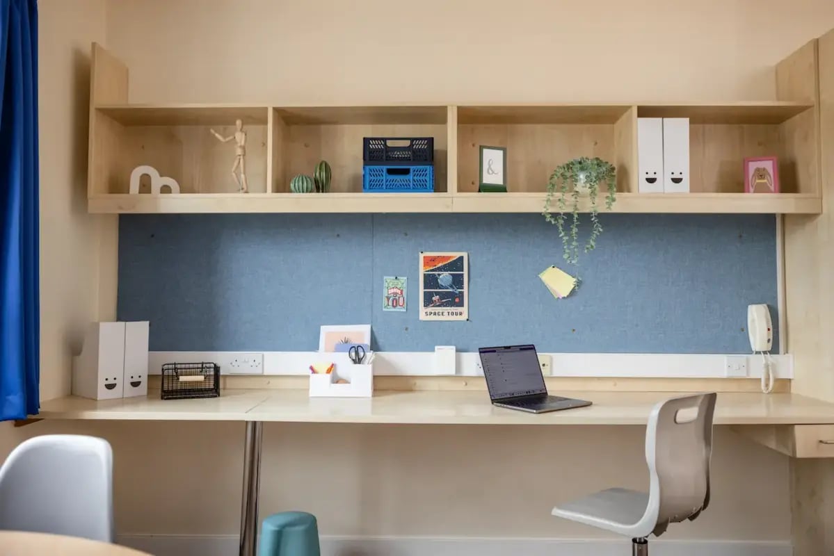 Desk with laptop shelves and blue noticeboard Study Area at Mcmillan student Village in Greenwich Student Accommodation
