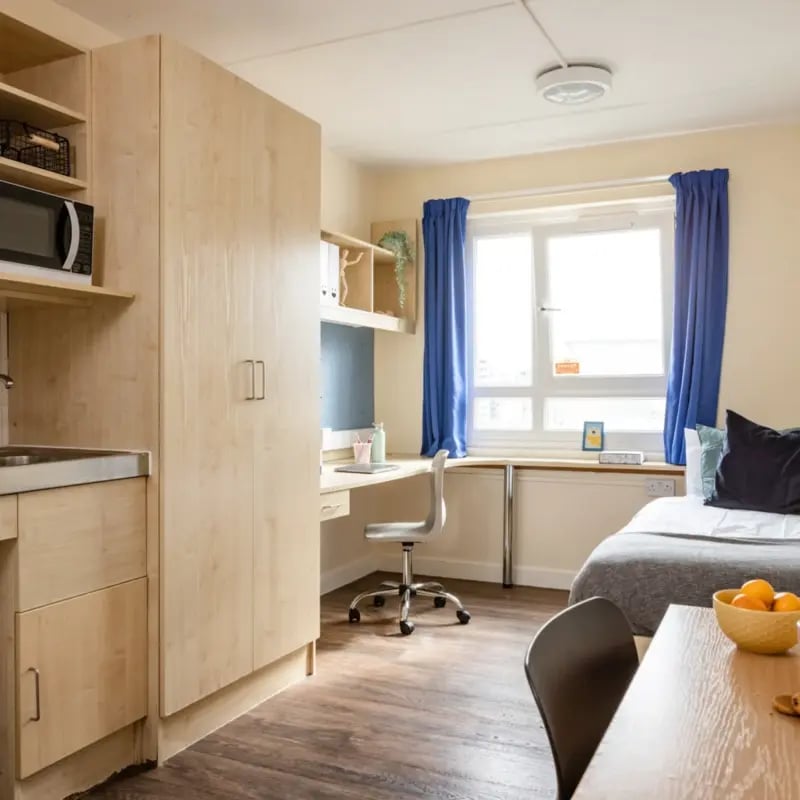 Studio apartment with bed desk and kitchenette bedroom at Mcmillan student Village in Greenwich Student Accommodation