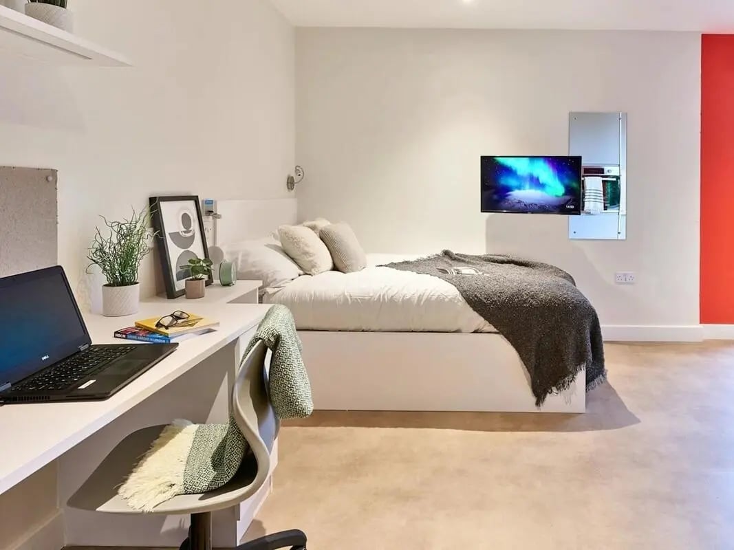 Desk laptop bed and TV bedroom at View Studios in London Student Accommodation