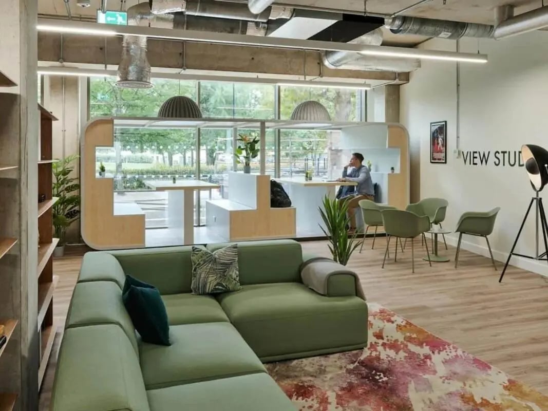 Green sectional sofa study booths and chairs Common area at View Studios in London Student Accommodation