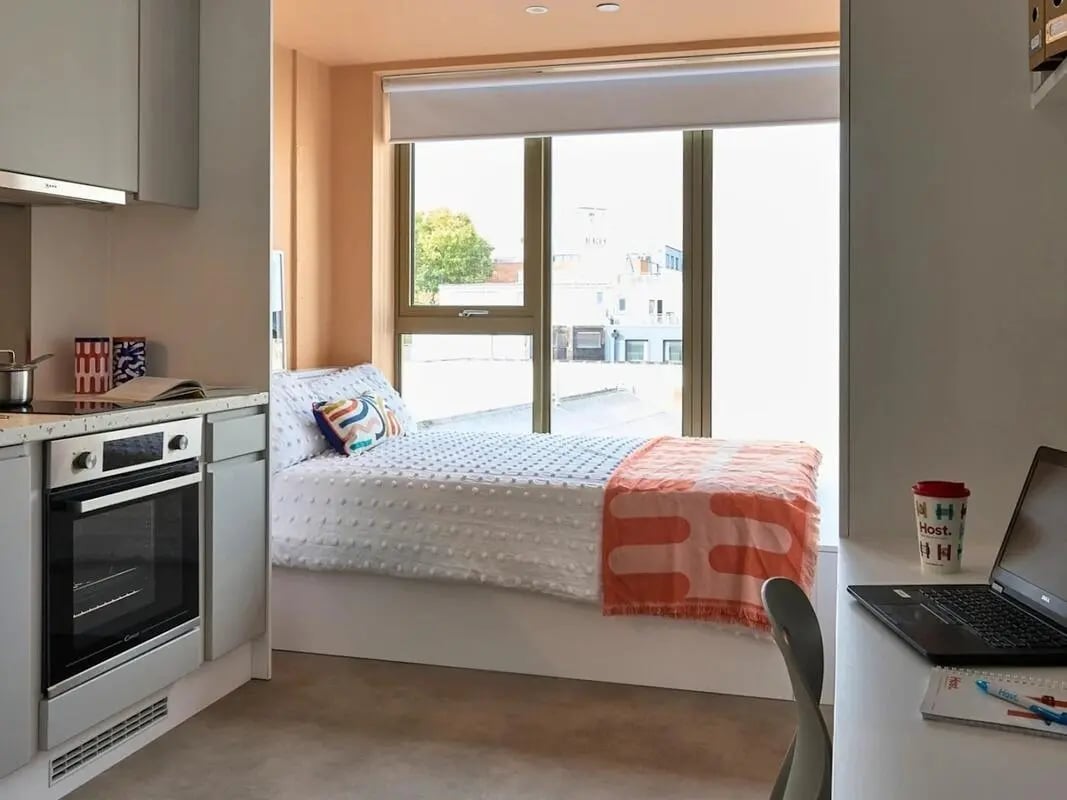 Bed kitchen oven desk laptop bedroom studio at View Studios in London Student Accommodation