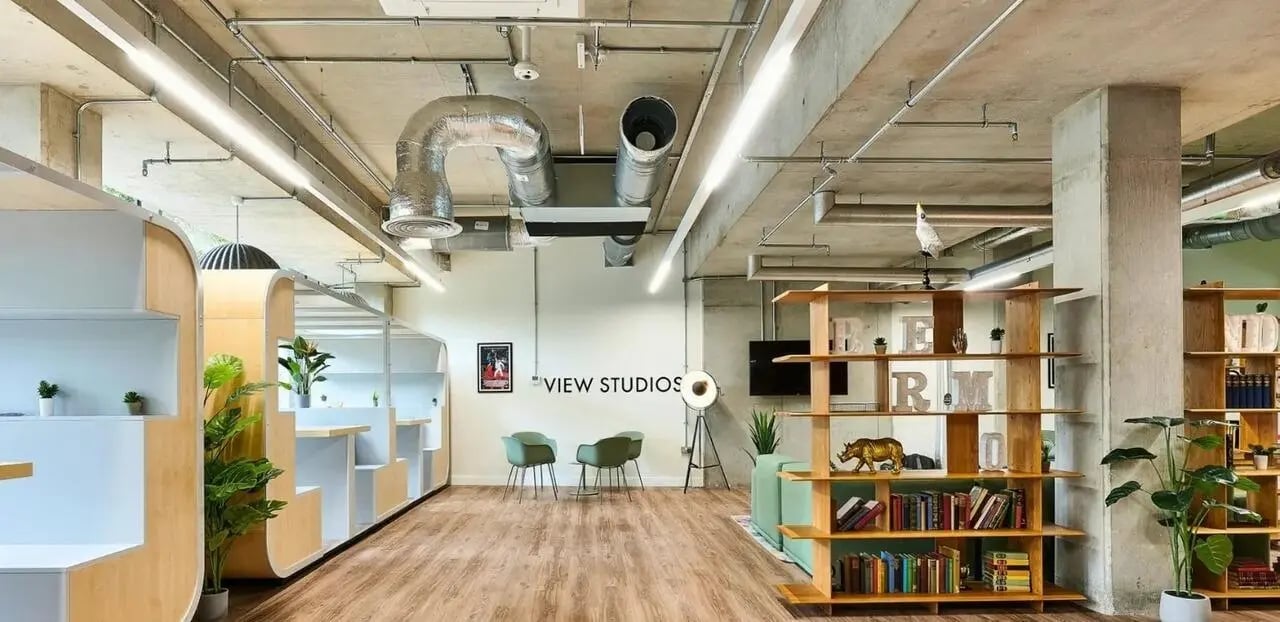 Study booths chairs bookshelf lounge area living room at View Studios in London Student Accommodation
