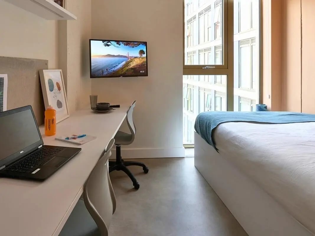 Desk laptop bed and TV bedroom at View Studios in London Student Accommodation