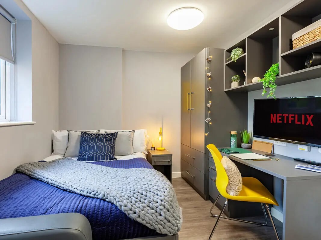 Bed desk wardrobe shelves and Netflix television Bedroom at Allen Court in Manchester Student Accommodation