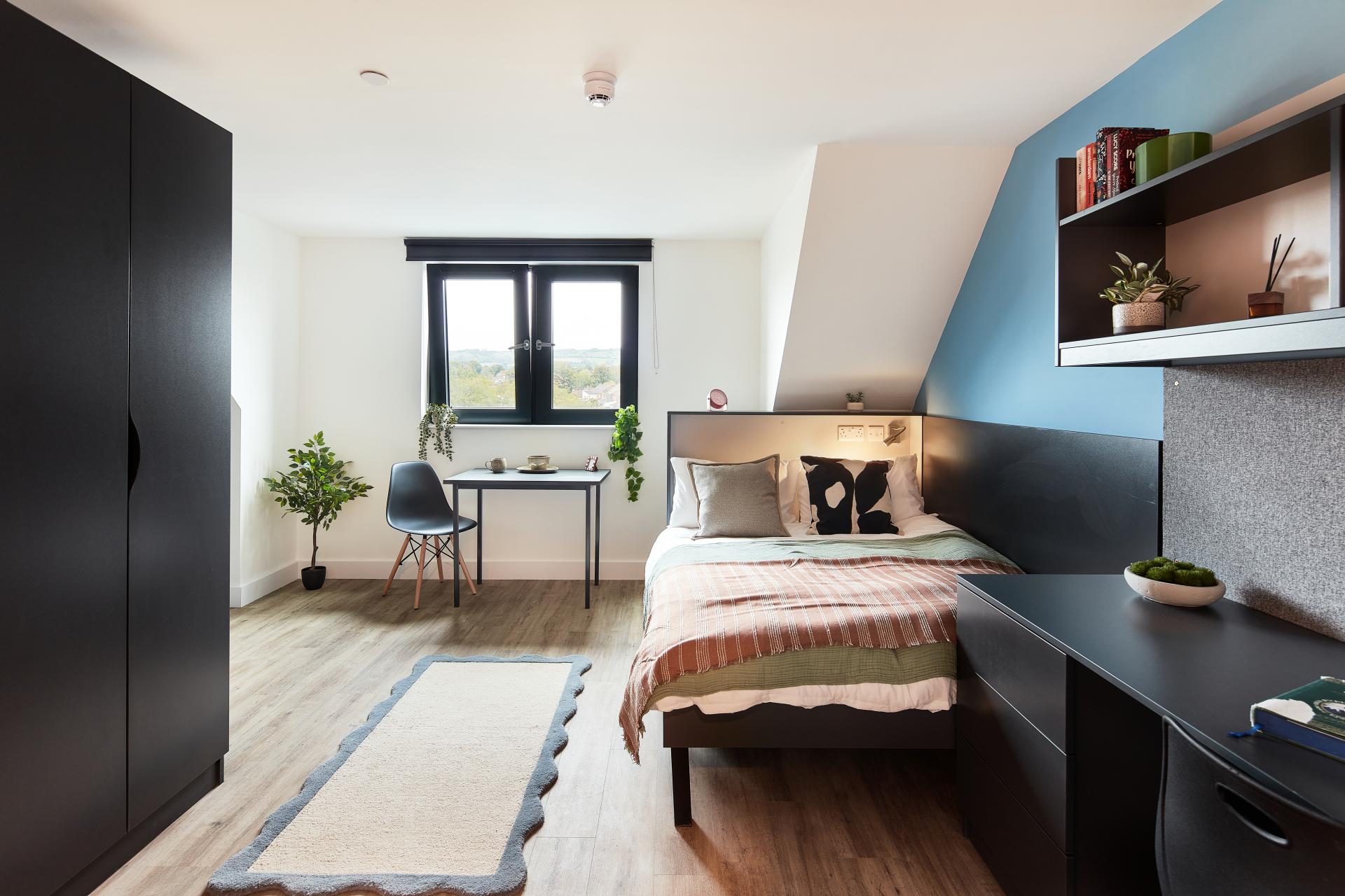 Wardrobe bed desk rug chair window bedroom at Hollis Wharf in Bath Student Accommodation