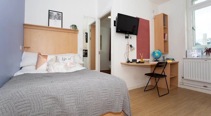 Bed with pillows and desk with chair bedroom at 200 Cowgate in Edinburgh Student Accommodation