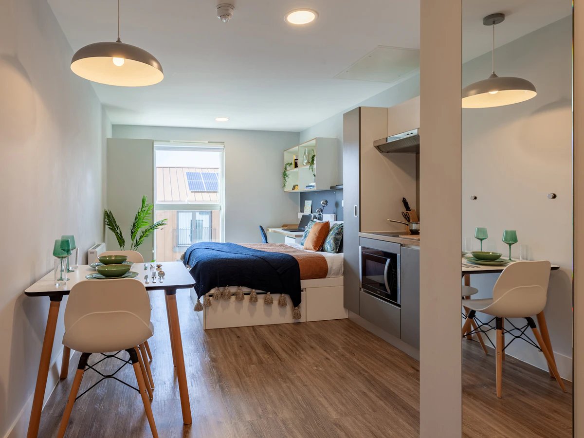 Bed kitchenette dining table and chairs living room at West Way Square in Oxford Student Accommodation