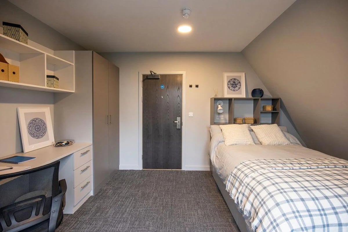 Bed desk shelves wardrobe with door bedroom at Ash Grove Court - Guildford in Guildford Student Accommodation