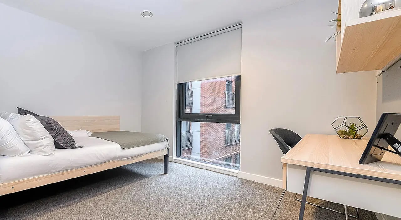 Bed desk chair and plants bedroom study area at Straits Manor in Sheffield Student Accommodation