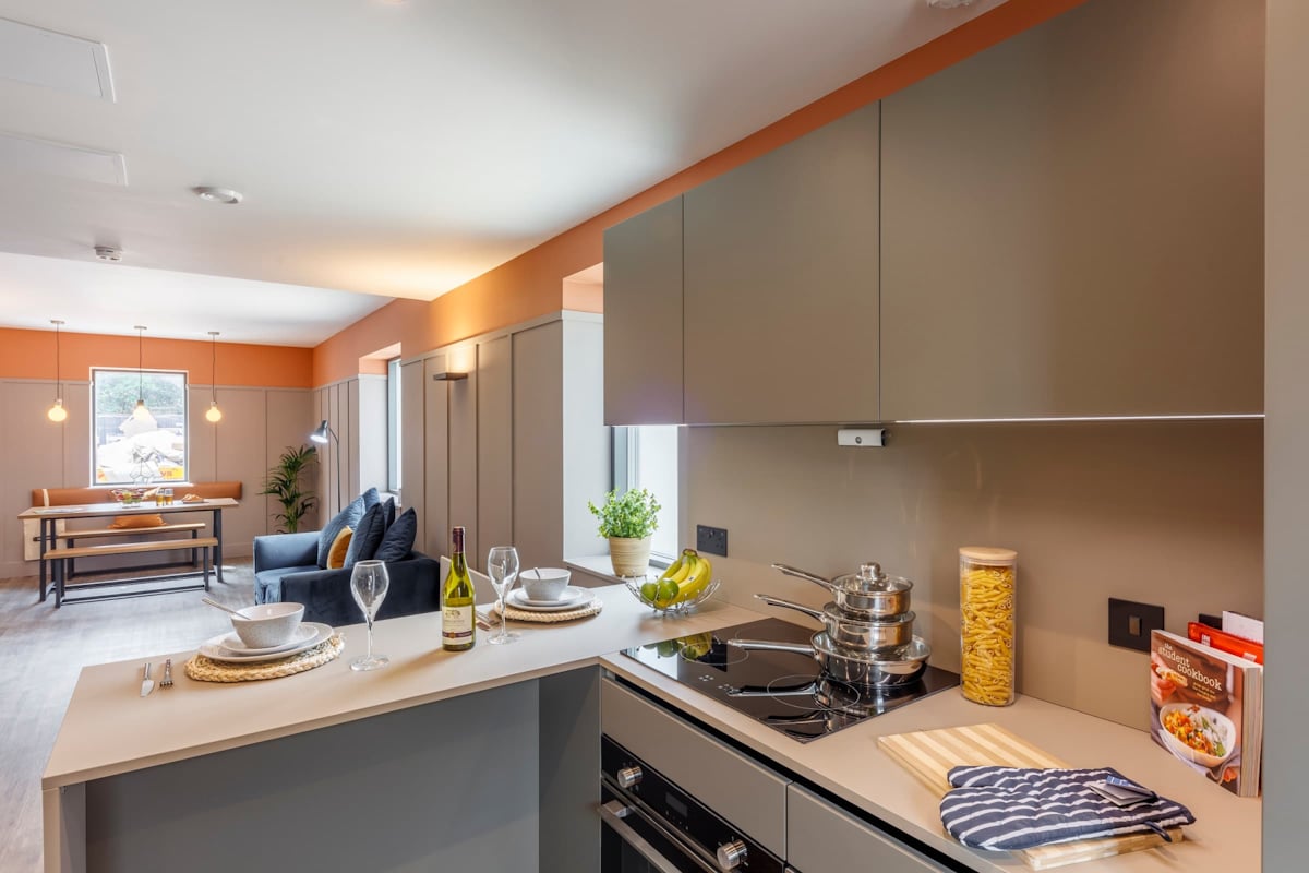 Kitchen island couch dining area living room kitchen at The Garage Egham in Egham Student Accommodation