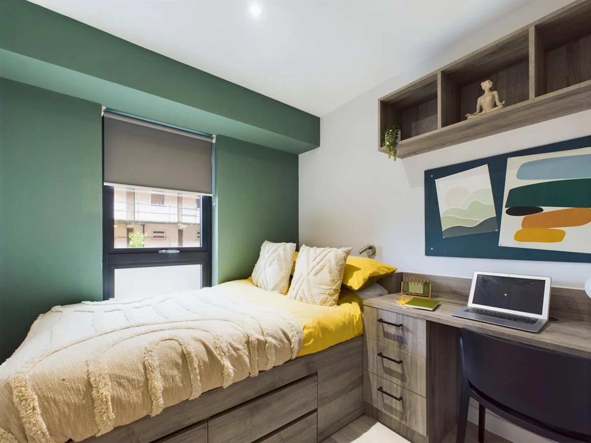 Bed with yellow pillows and desk bedroom at Crown Place - Nottingham in Nottingham Student Accommodation
