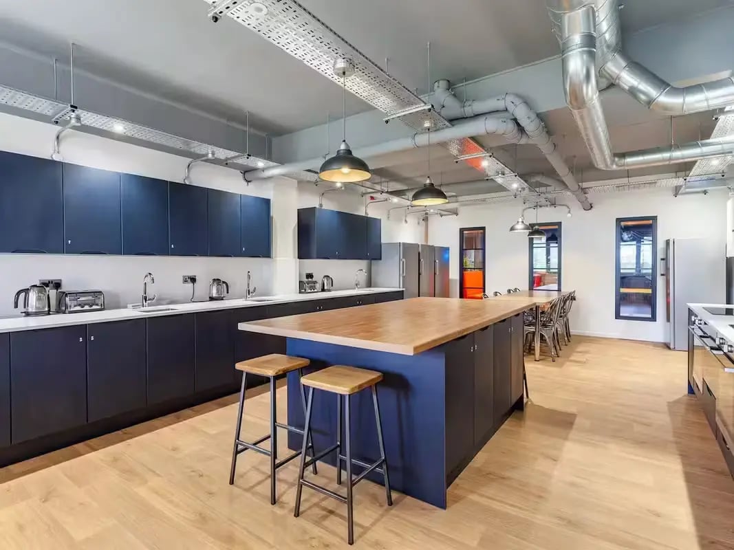 Modern kitchen island with stools and appliances kitchen at The Bridge Guildford in Guildford Student Accommodation