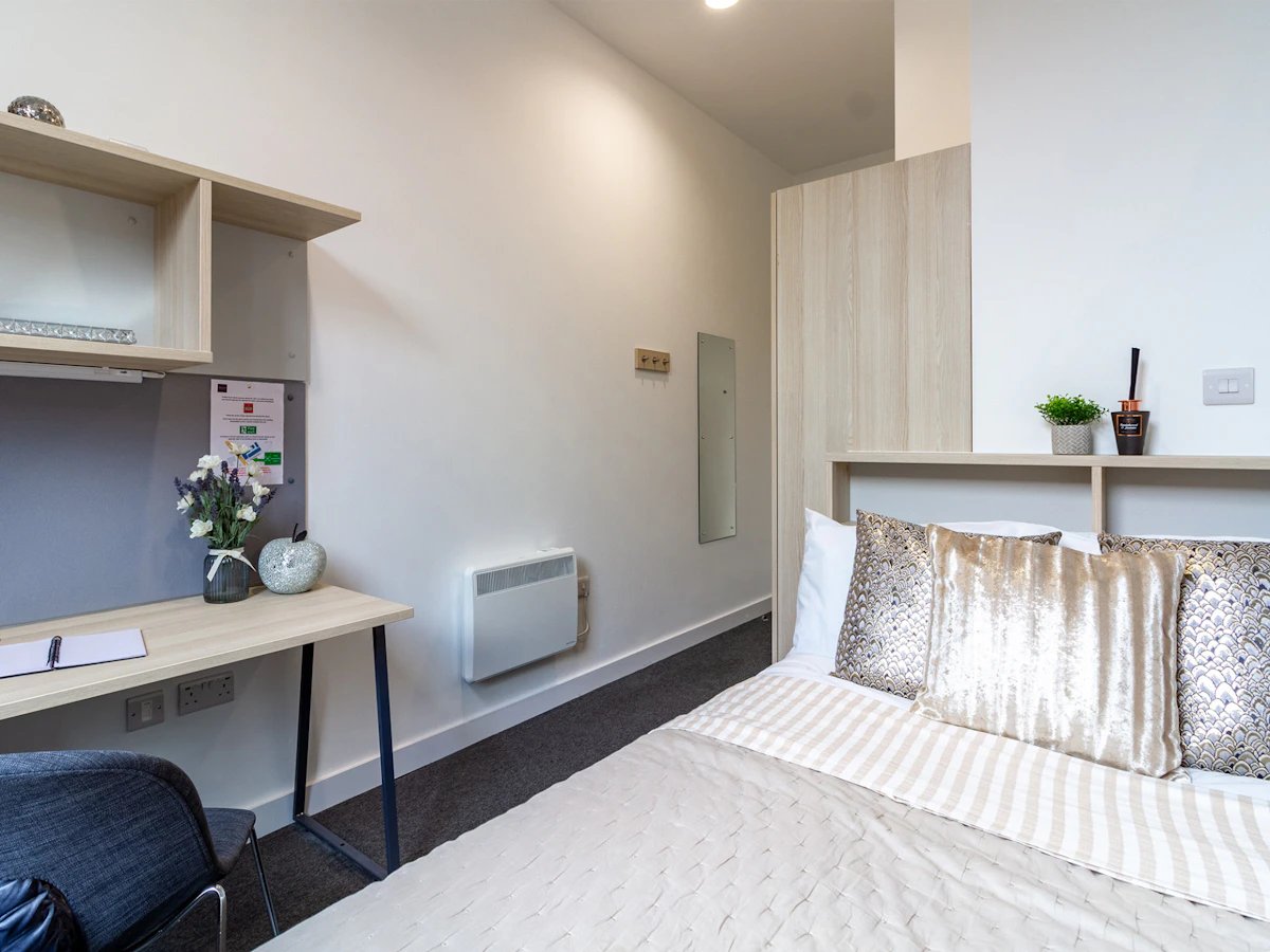 Desk with chair and bed with pillows Bedroom at Straits Village in Nottingham Student Accommodation