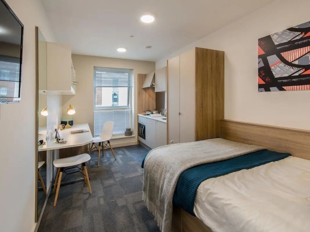 Bed desk kitchen area painting studio apartment at Berkshire House Reading in Reading Student Accommodation